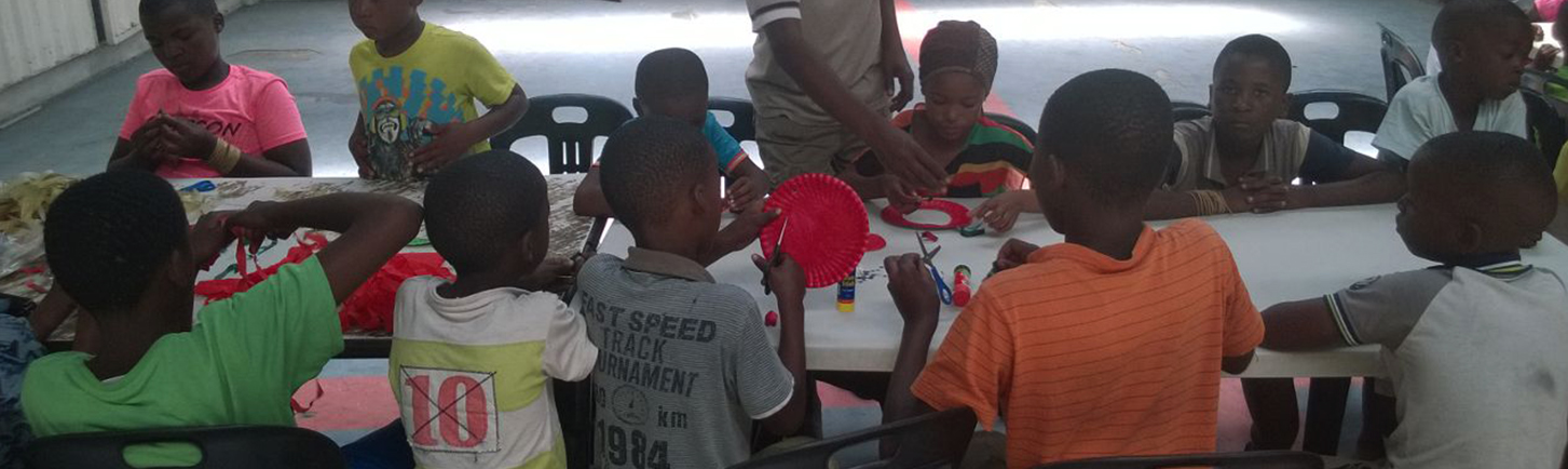 Homestead banner children doing arts and crafts