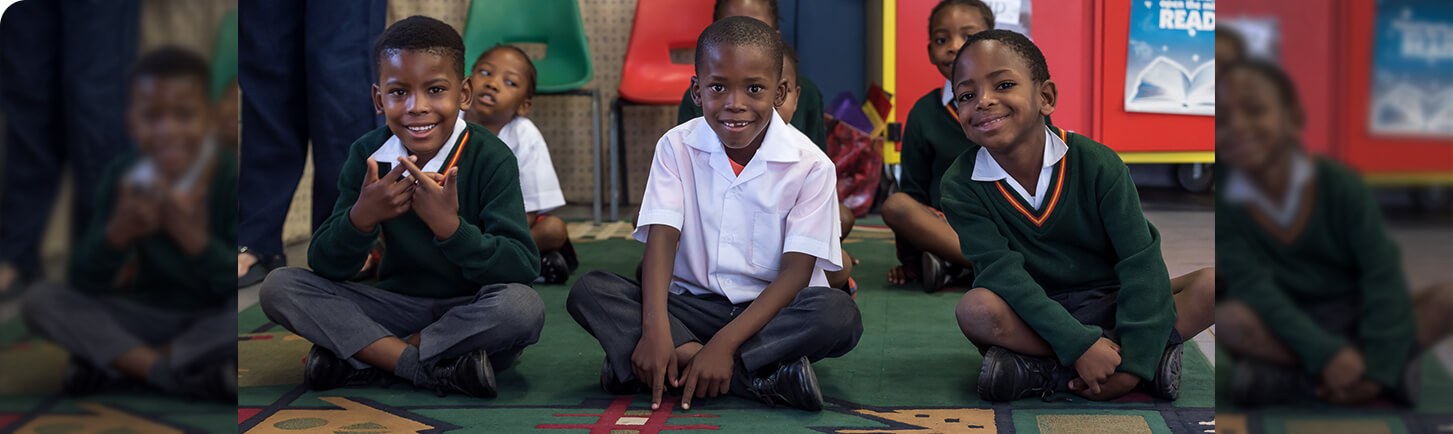 School children sitting on floor